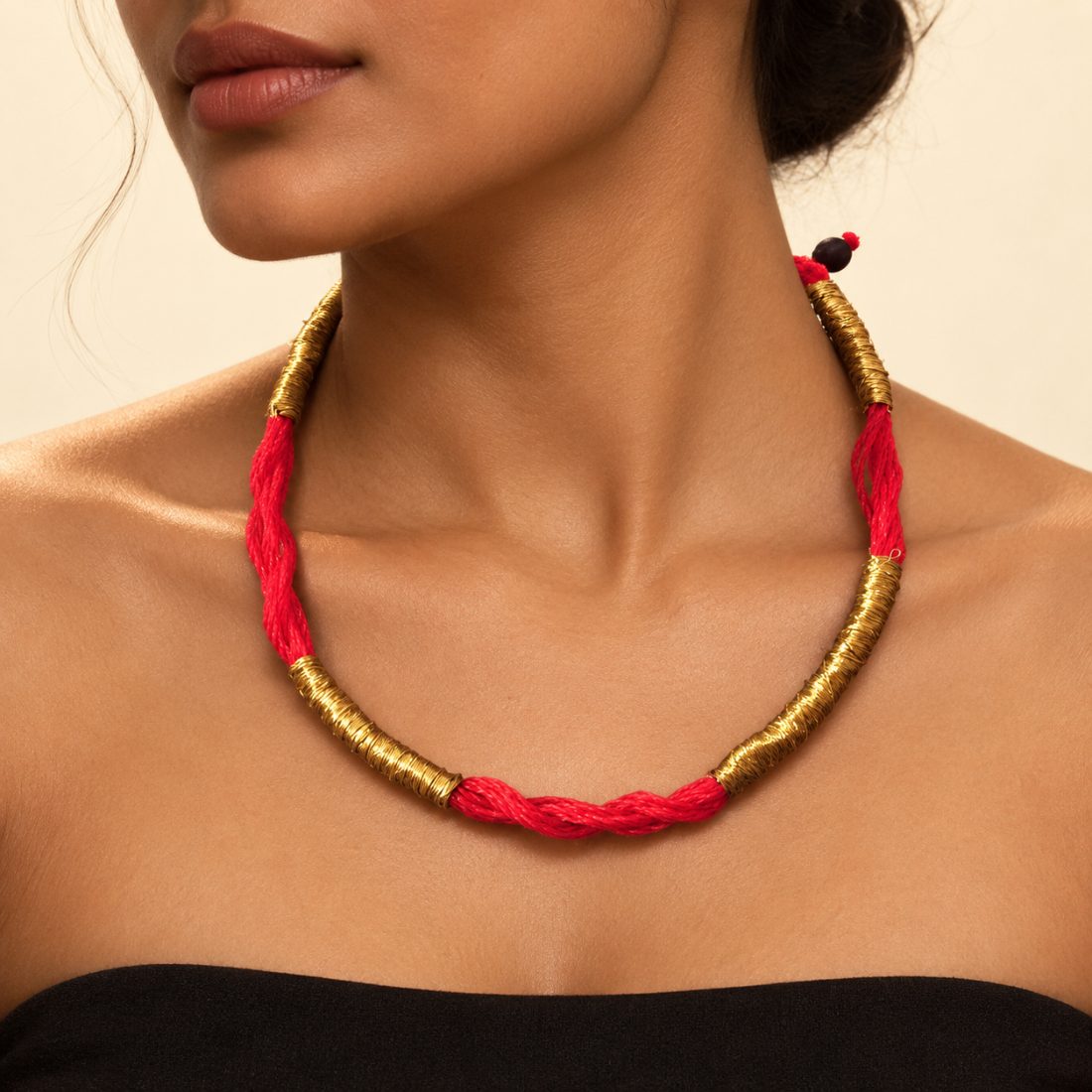 Buleji — red monofilament twist, brass-wrapped sections, one wooden bead for a clasp.