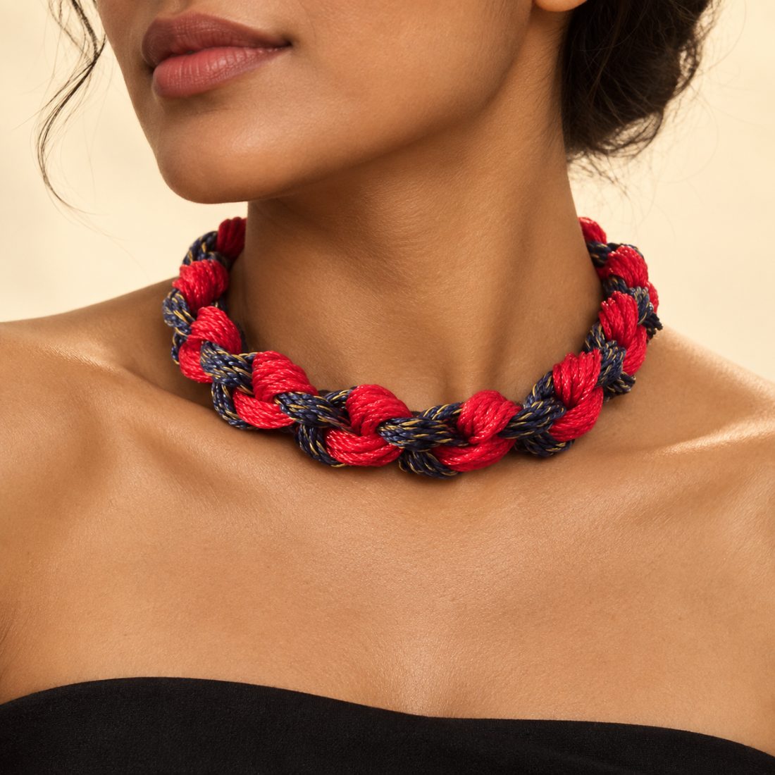 Rehri — crimson and navy net twine in a chain braid, gold thread pulled from a torn seine.