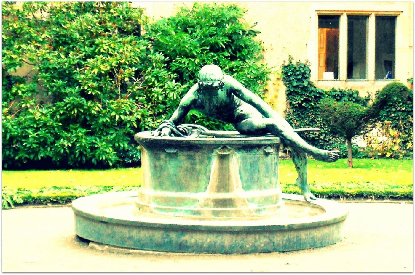 and in daylight: a bronze woman in an empty fountain.