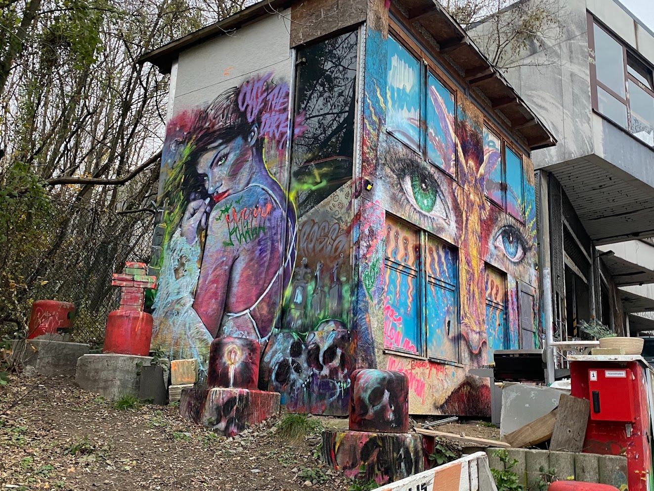 a painted shack in the trees — two faces, one eye, and CUT THE... the rest is gone.