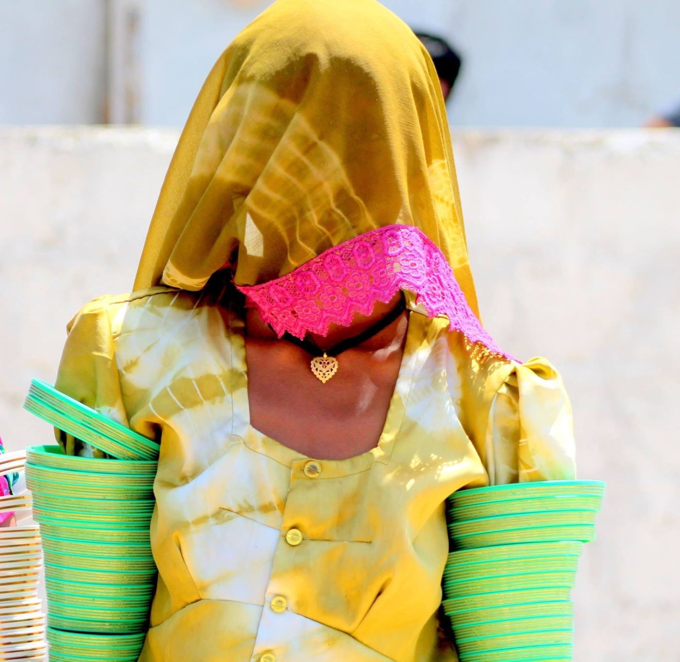 the veil covers the face; the bangles say everything anyway.