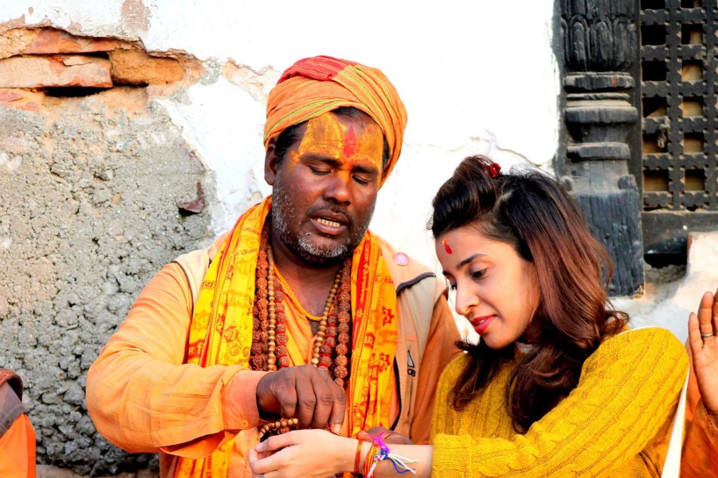 a sadhu ties a thread on my wrist