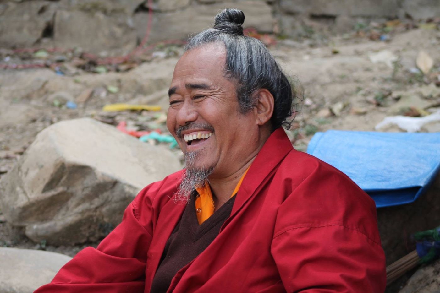 a monk in maroon, laughing at something he wouldn’t translate.