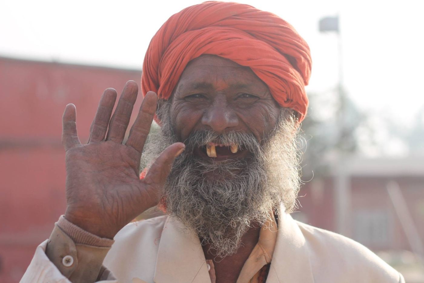 orange turban, white beard, a salute for the camera