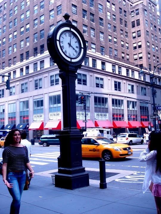 fifth avenue. the clock, the cab, the walk sign.