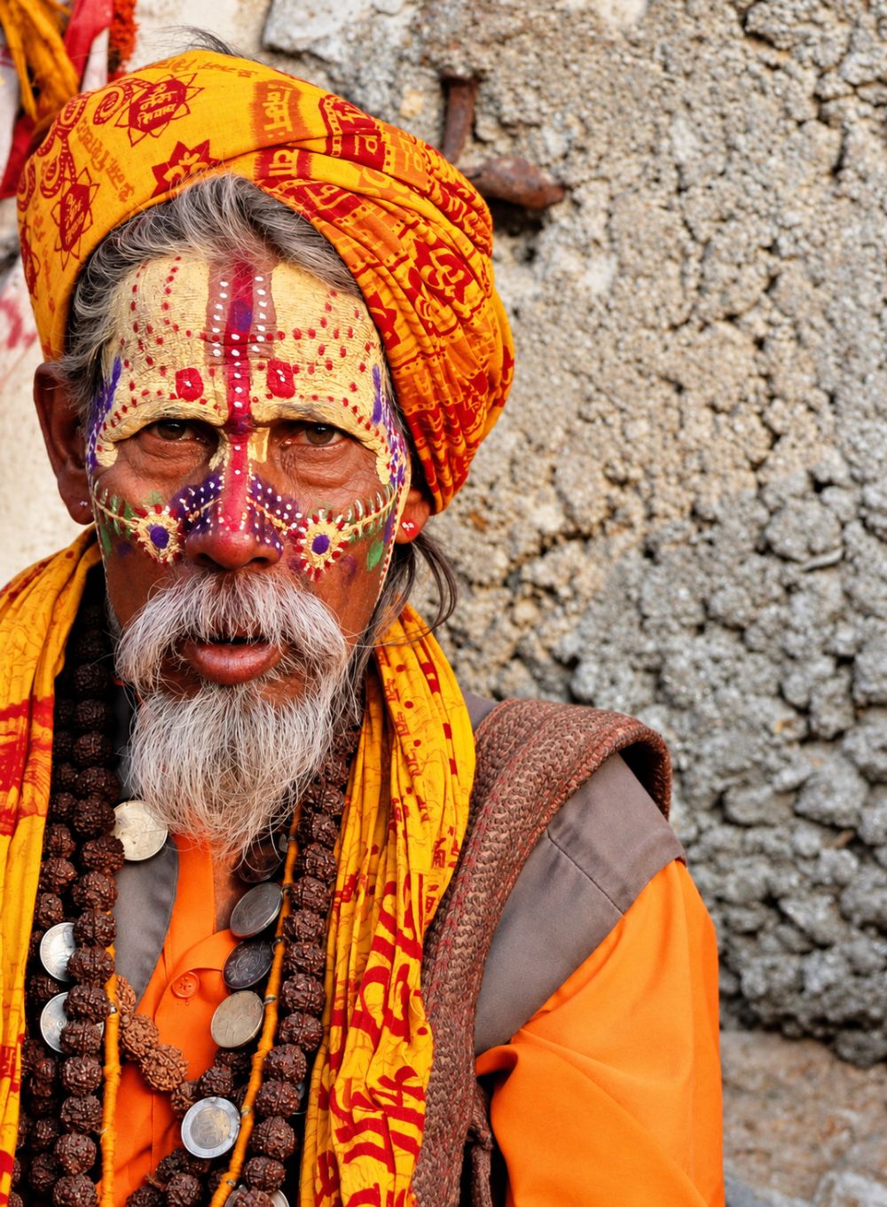 Close portrait of a sadhu with intricately painted face