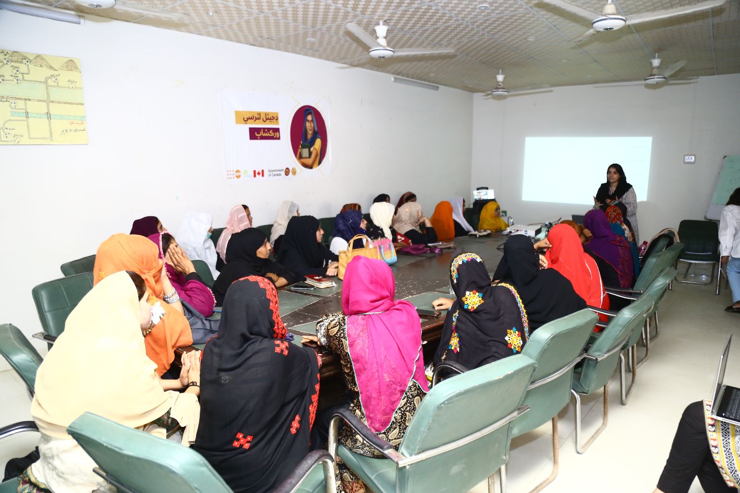 Champions training session, women watching a presentation