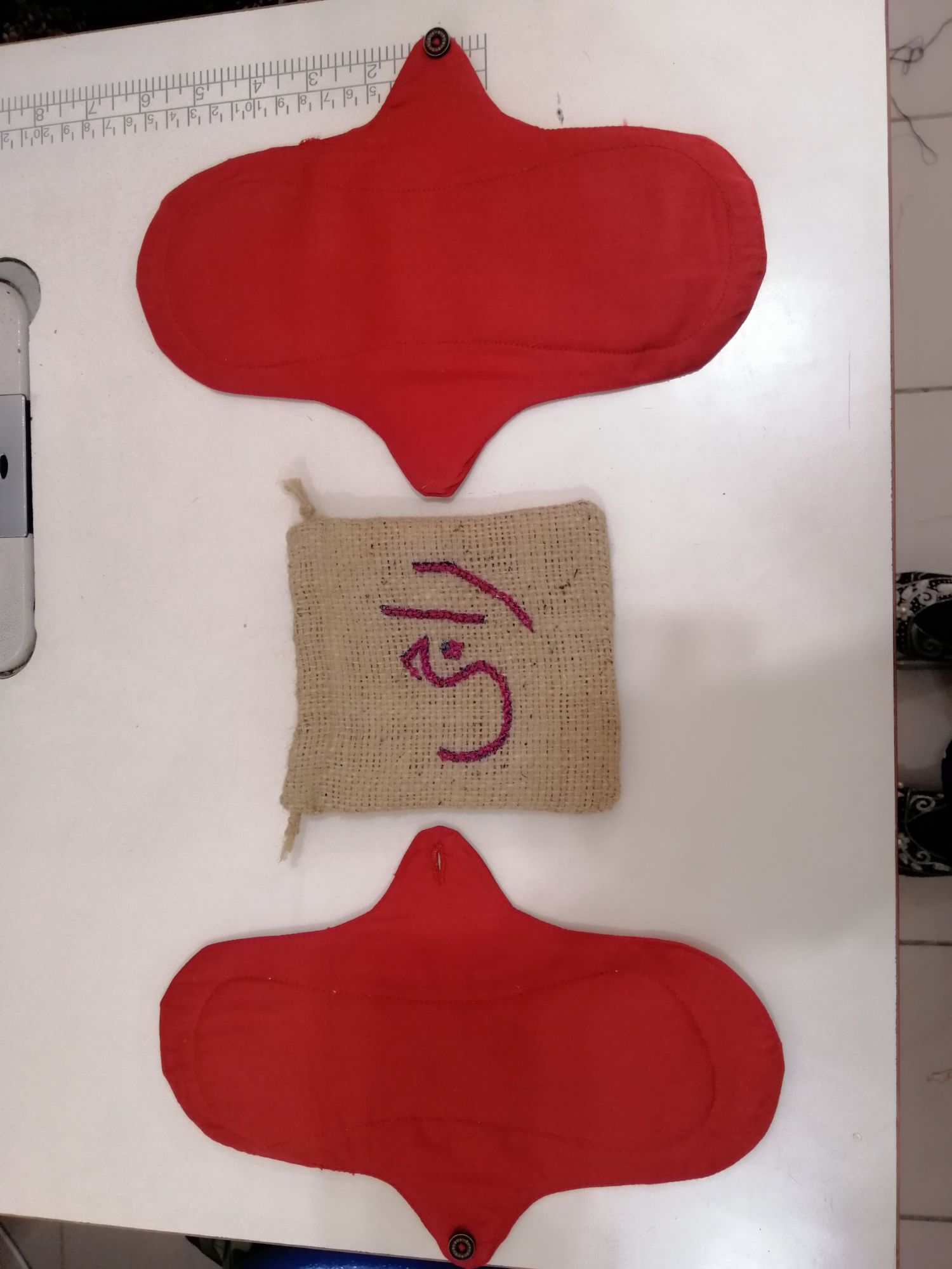 A symmetrical flat lay of pad pieces on a cutting mat
