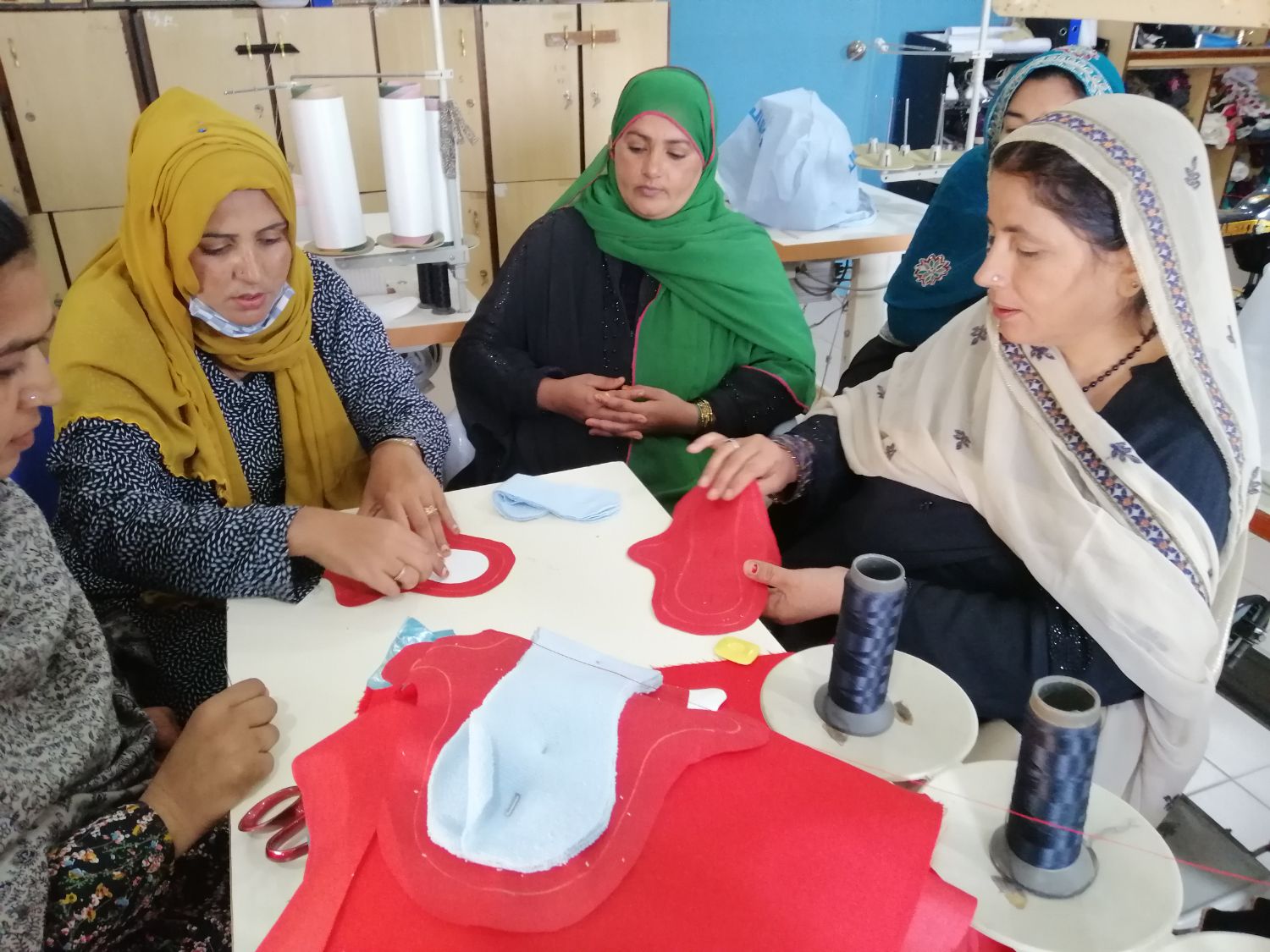 Meera demonstrates a pad template to Business Development Group women