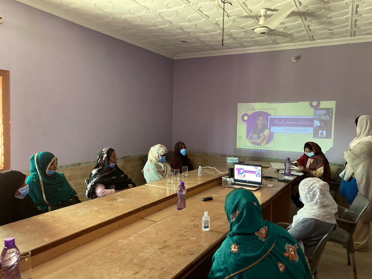 Women watching Raaji projected in Kambar Shahdadkot