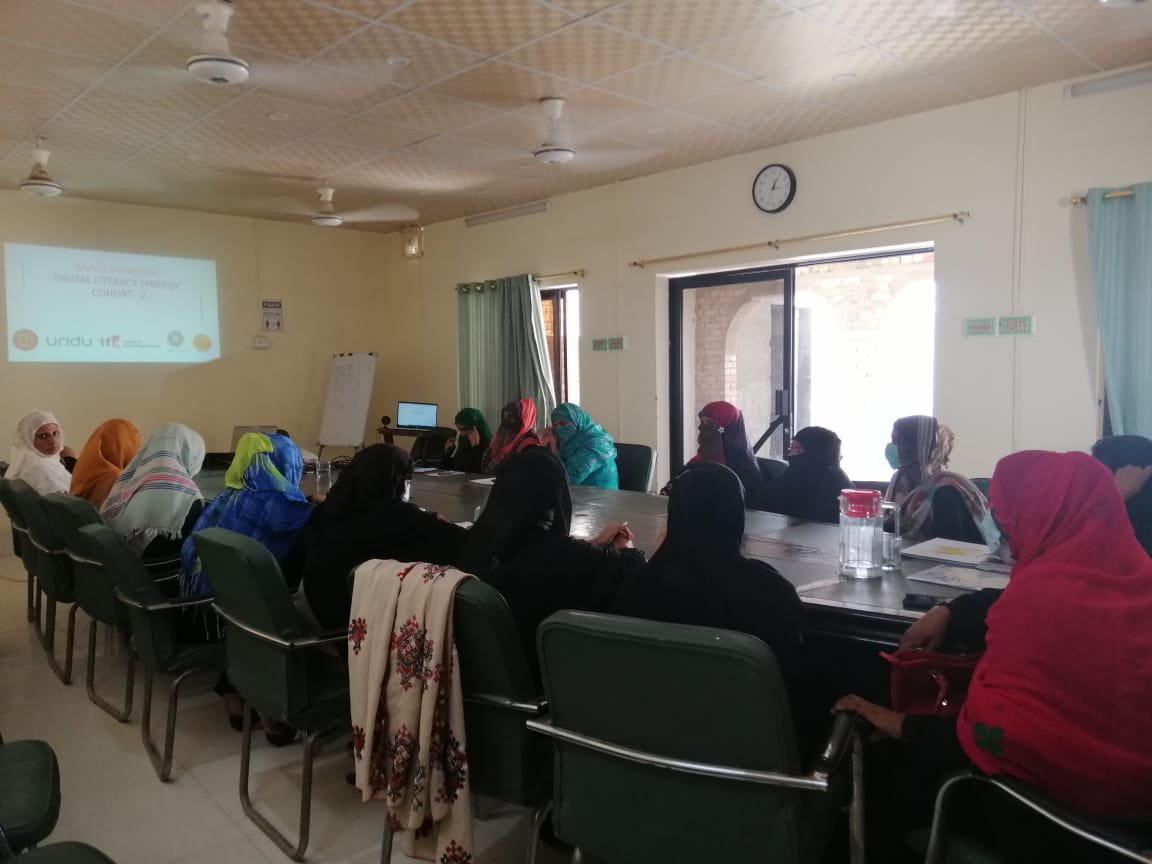 Women on a mat watching a laptop