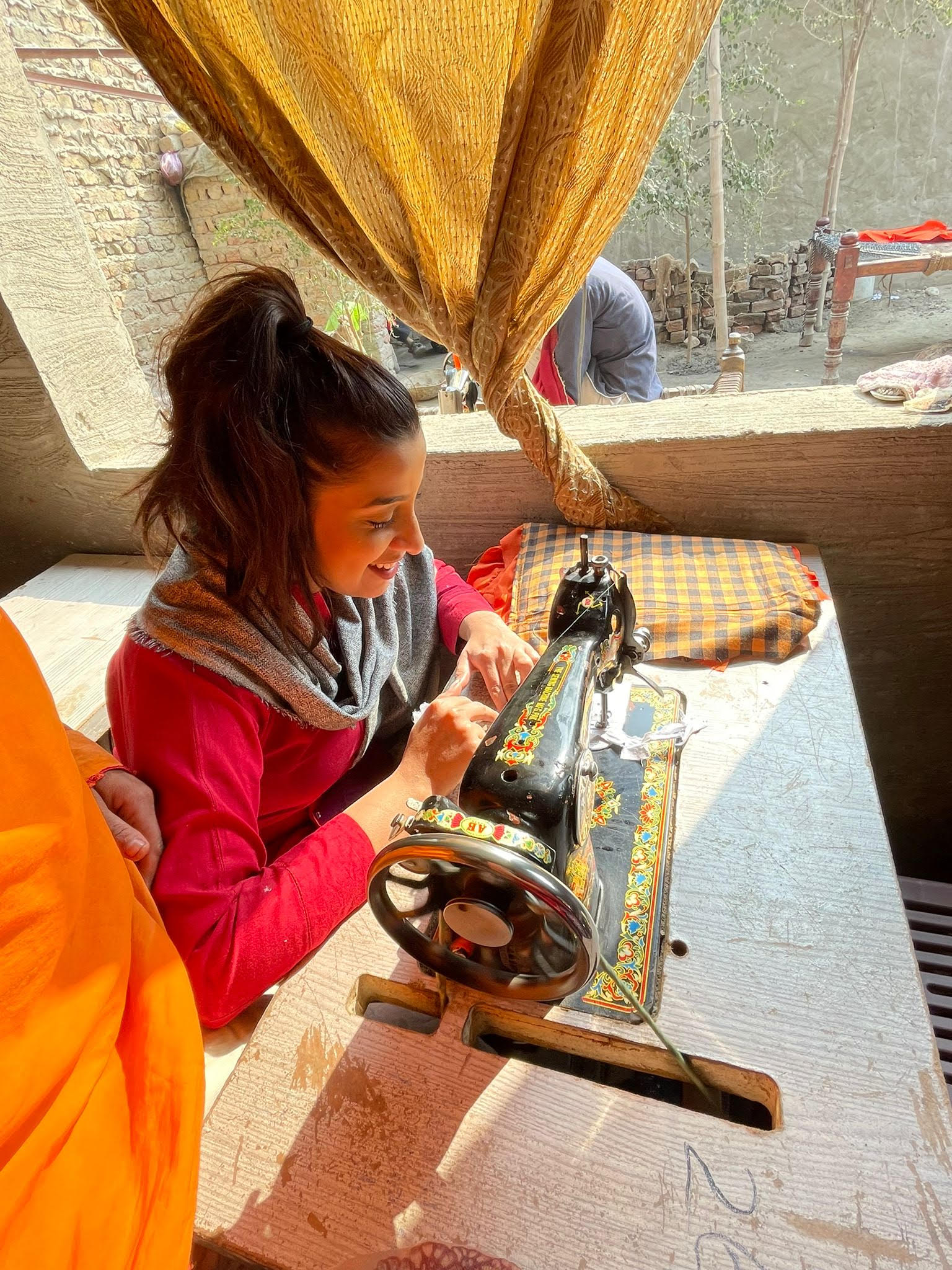 Saba learning to stitch from an artisan in Meero Khan