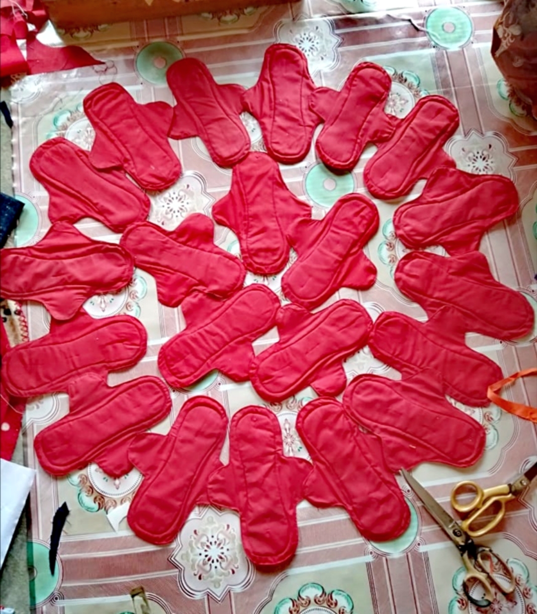 A sunburst arrangement of finished red pads laid out by Shazia’s artisan group