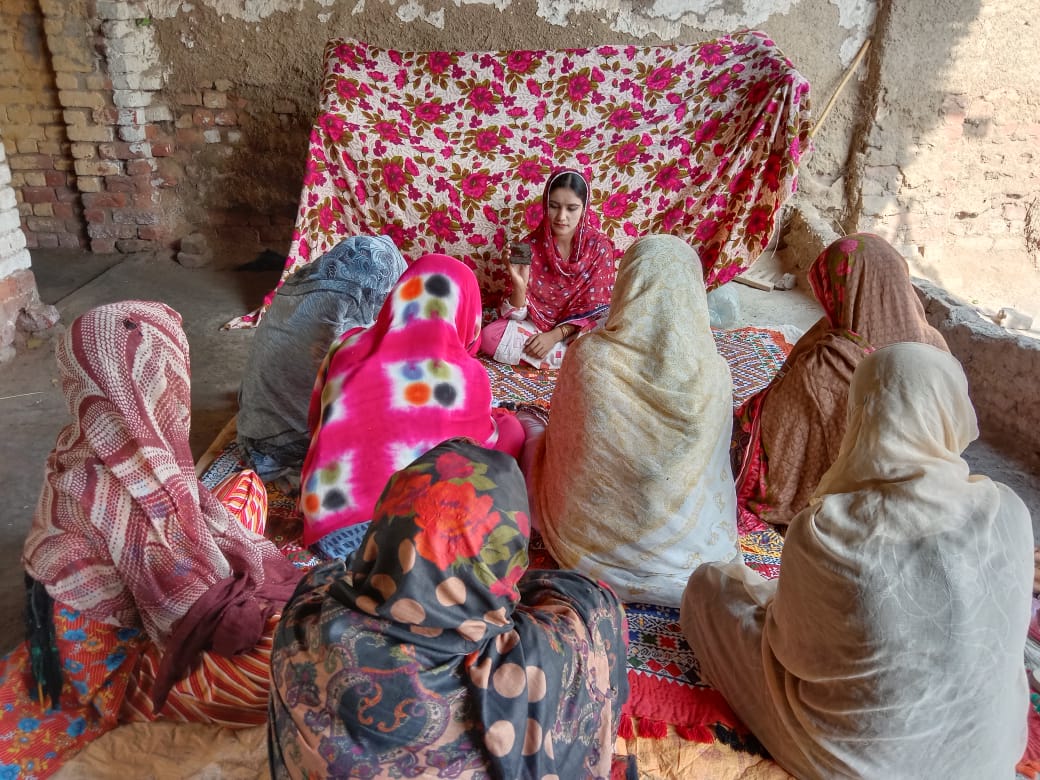 Women gathered for a listening party in Muzaffarana