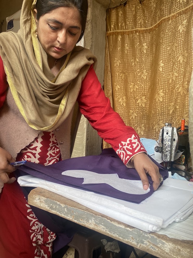 A vocational sewing classroom, two women teaching